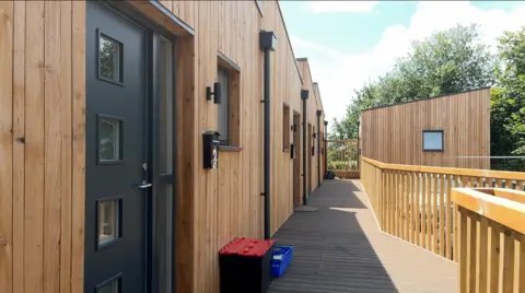 A small development of seven units with wooden facades, newly built in the Fishponds area.