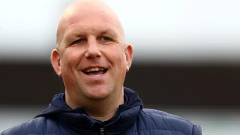 Matt Gray smiles during his time in charge of Sutton United