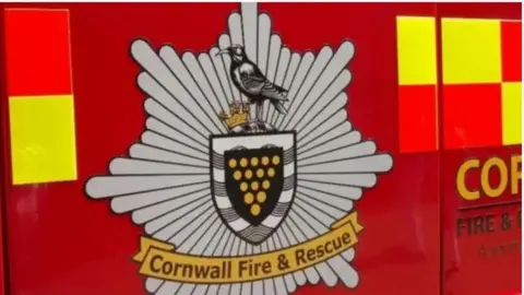 A fire engine with the crest of the Cornwall Fire & Rescue Service