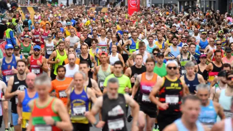 Run 4 Wales A assemblage  of runners astatine  the 2023 Cardiff Half Marathon successful  assorted  multicoloured vests and shorts