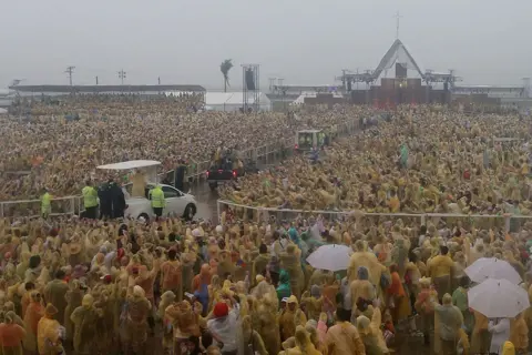 Pope Francis waves to the crowd after conducting mass at the Tacloban Airport in January 2015