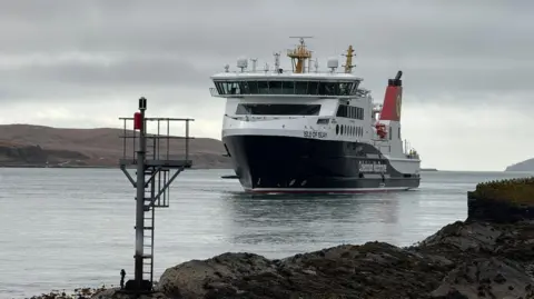 A black and white ship with red funnels and Isle of Islay written on the bow