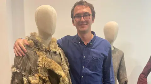 Isaac Hempstead Wright with his hand around his former Game of Thrones costume