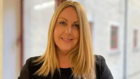 BBC A smiling blonde woman in a suit (Teresa Cope)