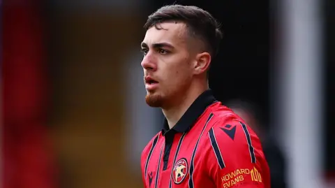 Taylor Allen prepares to take a throw in for Walsall