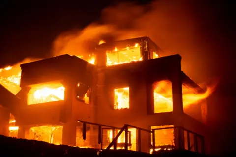 Image of flames engulfing a structure