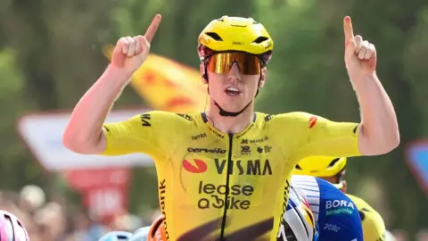 Matthew Brennan raises his arms in celebration 