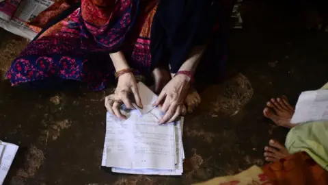 AFP An Indian Muslim woman makes paper bags at her home to sell it to shopkeepers in Allahabad on July 15, 2018. - Uttar Pradesh government has banned the use of polythene bags and items of common use made of plastic from July 15.