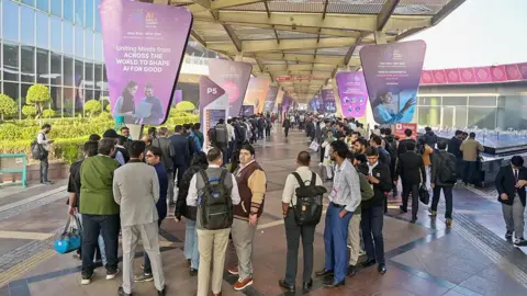 Getty Images International and domestic delegates stand in a long, winding queue at the India-AI Impact Summit 2026 on 16 February 2026 in New Delhi