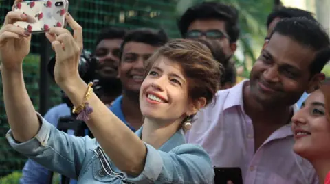 Getty Images Bollywood actress Kalki Koechlin takes a personal photo with fans