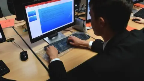 Get a school pupil on a computer