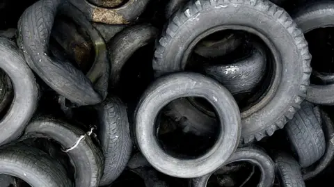 Getty A close-up shot of a pile of different-sized old tyres laying on top of each other. 