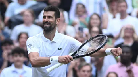 Novak Djokovic celebrates winning his 100th match at Wimbledon with a dance on Centre Court