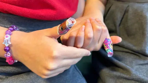 The girls' thumbs with plasters following their blood tests 