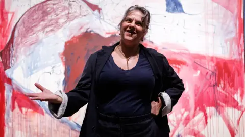 English artist Tracey Emin poses with her painting titled The End of Love during a photocall for the upcoming Tracey Emin: A Second Life exhibition at Tate Modern in London
