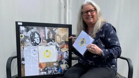 Hansons Claire Howell posing with collage and vinyl