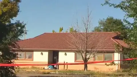 The funeral home, cordoned off with red police tape