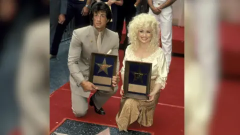 Dolly Parton and Sylvester Stallone honoured with stars on the Hollywood Walk of Fame.