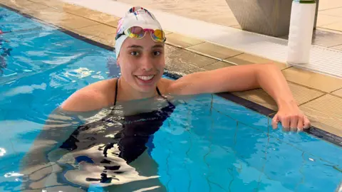 Isabella Haynes poses for a photo in the swimming pool