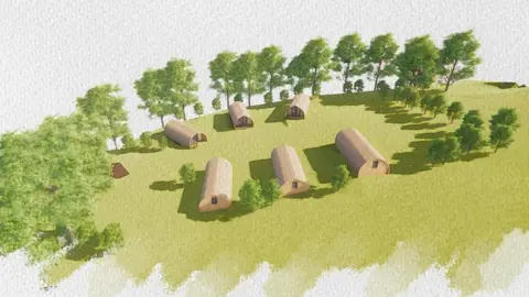 An artist's impression of plans for the development at Alma's Meadow, Smithy Lane, Bowness-on-Windermere. The watercolour-style drawing shows six holiday cabins in a grassy area surrounded by trees. They are long, single-storey buildings with curved roofs, somewhat like old style military accommodation.