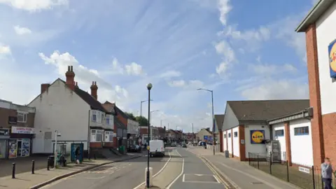 A shopping street with speed bumps and street lights