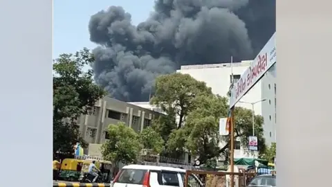 Plumes of black smoke in the sky