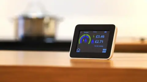 An electric heating monitor on the table top in a kitchen.