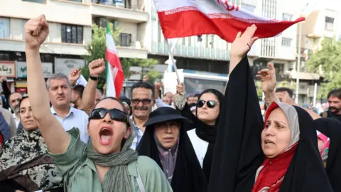 EPA Iranians shout slogans during an anti-US and anti-Israel demonstration in Tehran, Iran (22 June 2025)