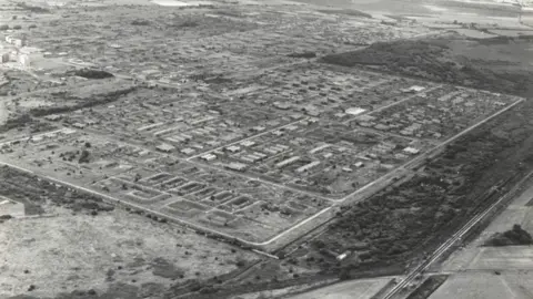 Reproduced courtesy of Cheshire Archives A black-and-white image showing an aerial view of ROF Risley in the 1970s.