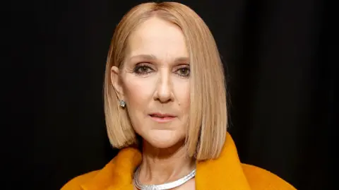 Getty Images Celine Dion looking at the camera behind the scenes at the 2024 Grammy Awards
