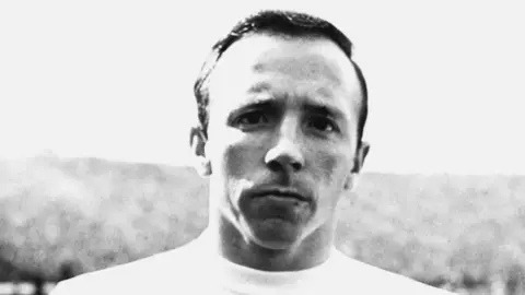 PA Media Image is a black and white photo of Nobby Stiles, in an England shirt, during his playing career