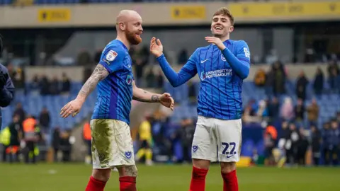 Connor Ogilvie (left) and Zak Swanson (right) celebrate after playing against Oxford United
