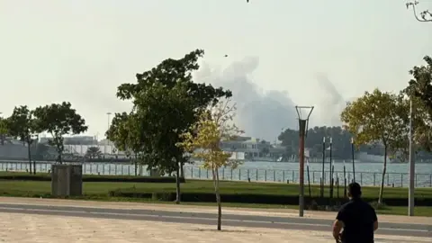 Reuters A photograph of a man looking at the smoke in the sky 