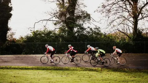 Scott Ramsey Cyclists on bikes on the velodrome at Preston Park