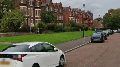 Google Image shows Newsham Park Drive, a long wide street of Victorian era three-storey red-brick houses 