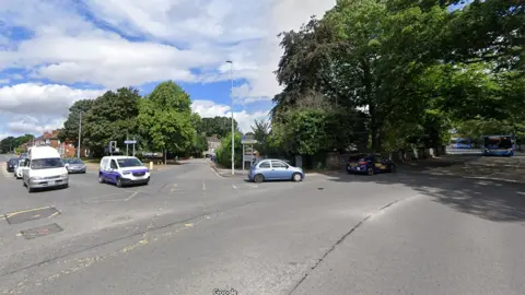 Google Bargate junction showing a number of cars turning down a tree-lined street
