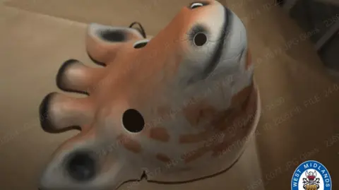 West Midlands Police A plastic mask in the shape of a giraffe