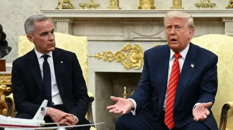 Mark Carney sitting next to Donald Trump at the White House in May