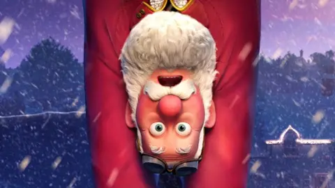 Santa Claus hanging upside down, clinging on to his sackful of presents as they dangle beneath him, in a promotional still for Netflix's That Christmas