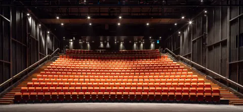 Peter Cook The new auditorium is pictured comprising of 550 orange seats with steps alongside them and spotlights up above