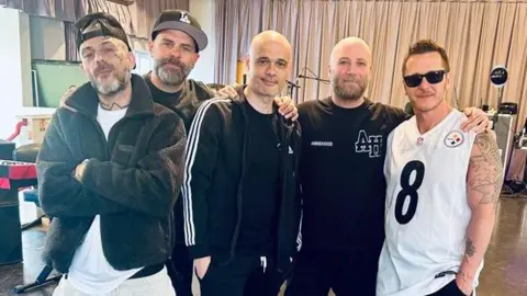 Boyband Five pose in the studio. 