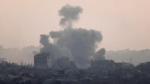 Smoke rises from Gaza after an explosion, as seen from Israel (29 May 2025).  