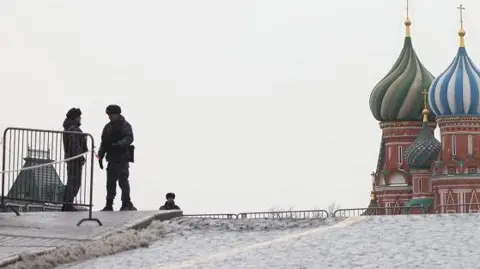Getty Images Two police officers stand guard in Moscow (file photo)