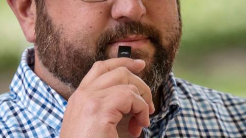 A person uses a Juul Labs Inc. electronic cigarette device in San Francisco, California, U.S., on Monday, June 24, 2019.