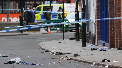 Jacob King/PA Wire Shoes and blankets at the scene