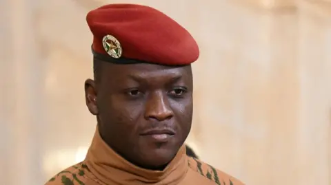 Reuters A close up picture of Ibrahim Traoré wearing a red military beret.