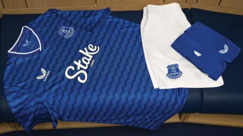 Everton's 2025-26 home kit lay on a bench
