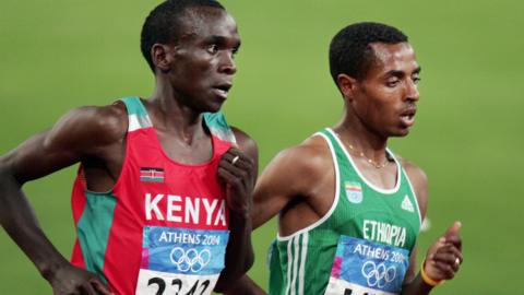 Eliud Kipchoge of Kenya and Kenenisa Bekele of Ethiopia running in the 5,000m final at the 2004 Olympic Games