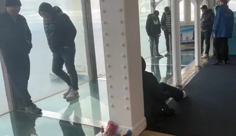 Rebecca Randle People waiting to be rescued stand on the 'Walk of Faith' glass floor at the top of Blackpool Tower.