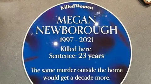 Newborough Family A blue plaque created with Megan's name and her birth and date of death. It reads: Killed here. Sentence: 23 years. The same murder outside the home would get a decade more. It's part of a campaign by the charity Killed Women.